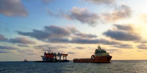 Two offshore support vessels at golden hour